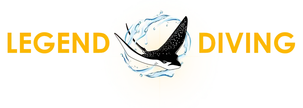 Yellow LEGEND DIVING text flanking a black-and-white spotted manta ray amid a blue water splash over a pale circular background.